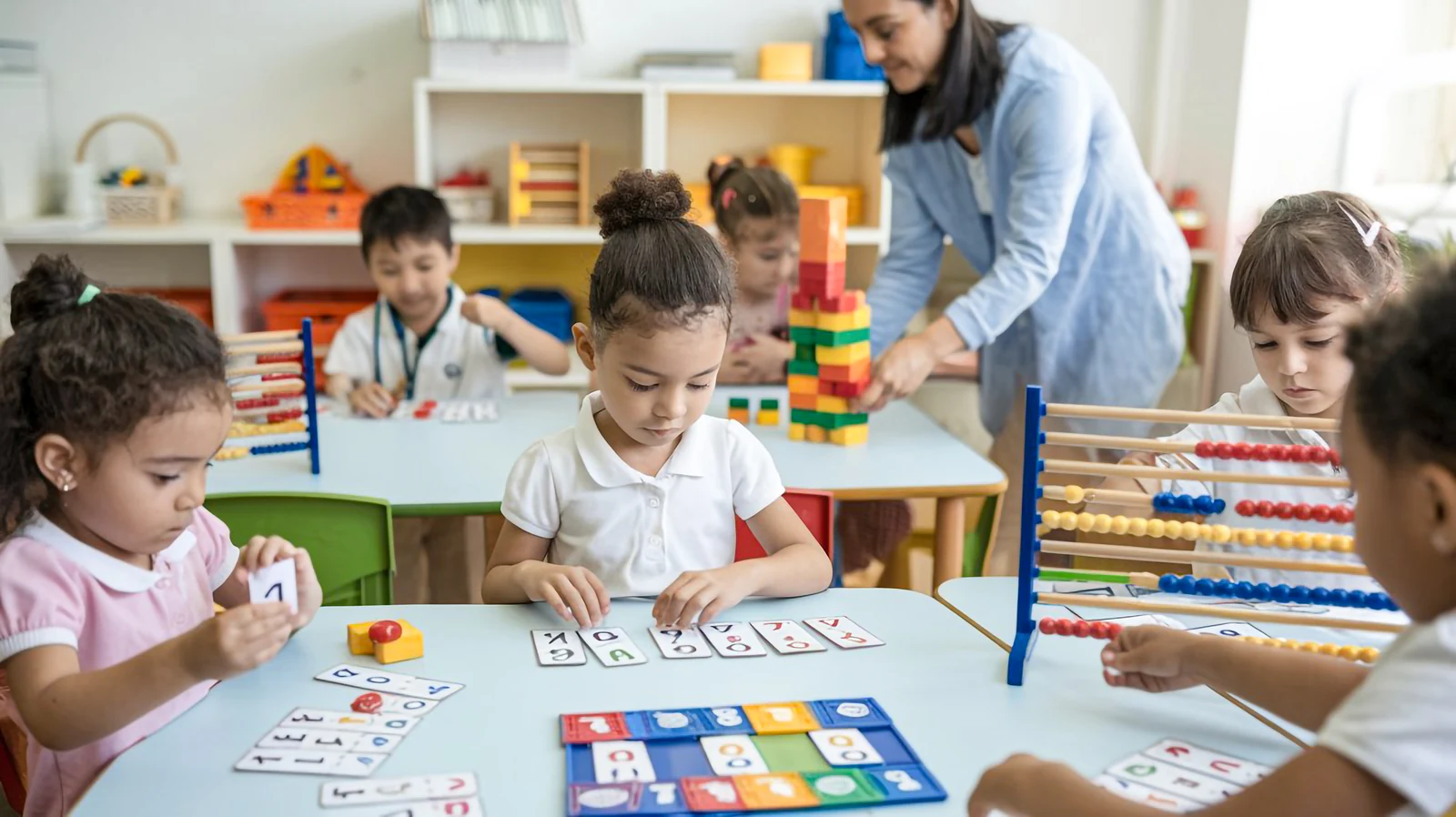Children learning through play with a teacher in a preschool classroom